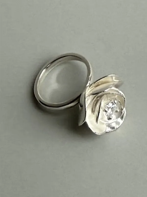 Two silver rings, one set with a pearl