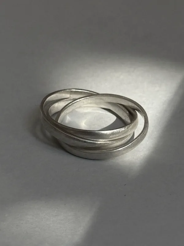 A set of fine silver bangles on a pale background